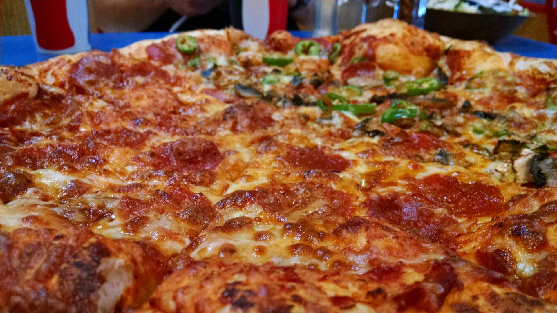 a close up of a pizza with pepperoni and cheese on a table .