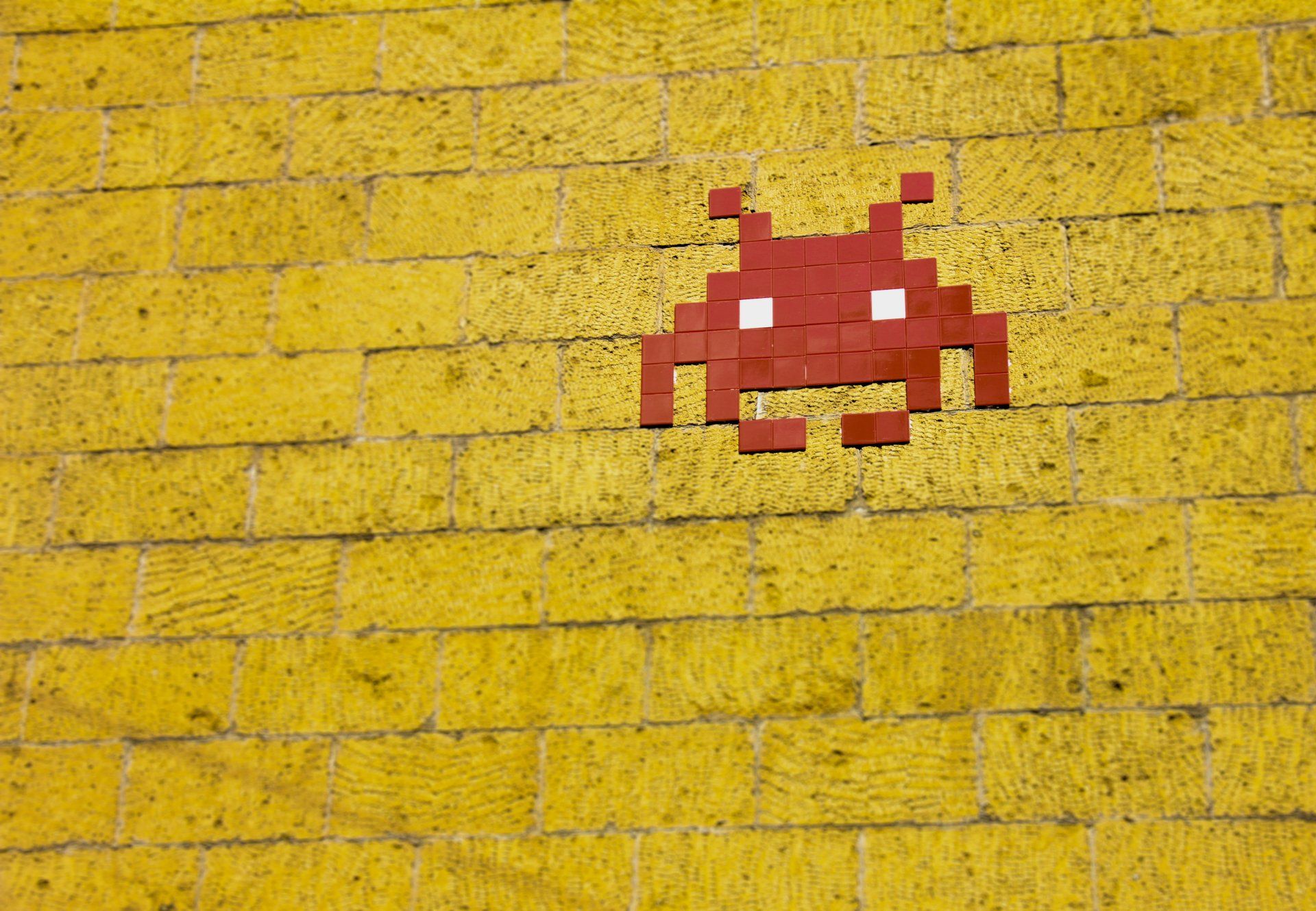 A space invader graphic on a wall in this cool photo