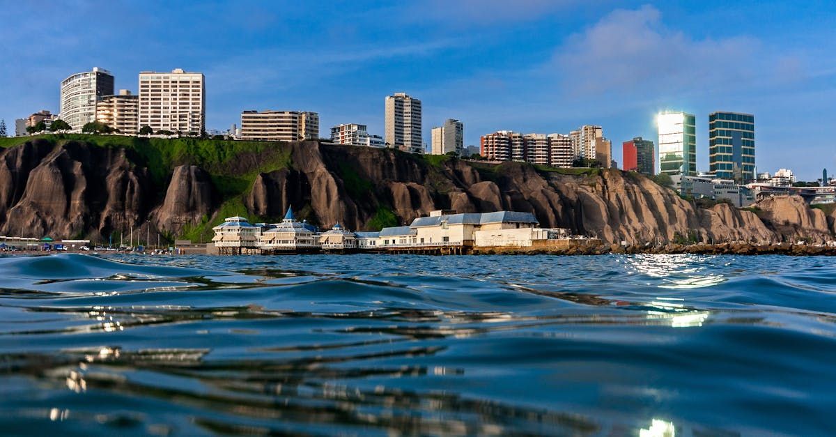 A view of a city from the water with a city skyline in the background.