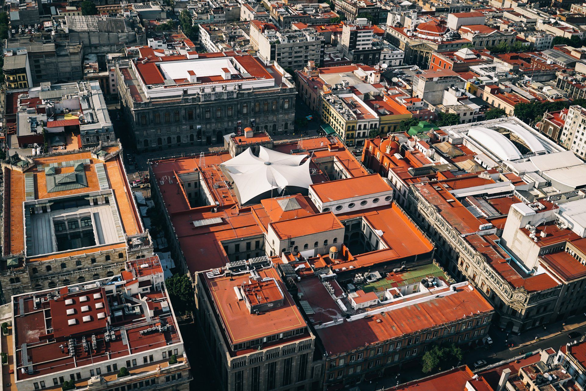 An aerial view of a city with lots of buildings and roofs