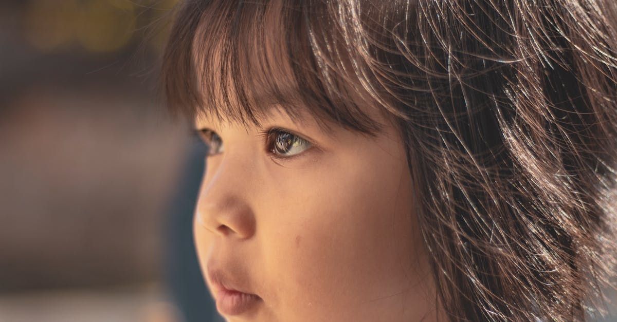 A close up of a young girl 's face with a serious look.