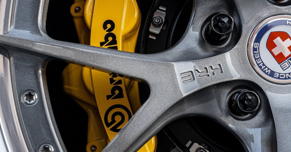 A close up of a car wheel with yellow brembo brakes | EK Automotive Ltd.