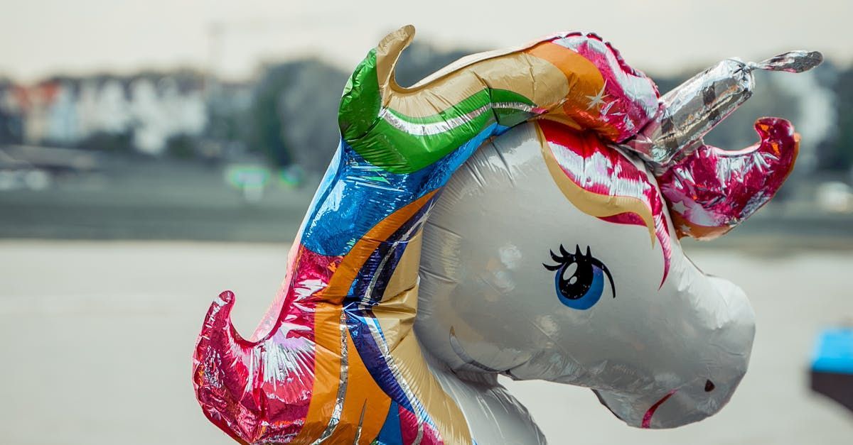 A balloon in the shape of a unicorn with a rainbow mane and tail.