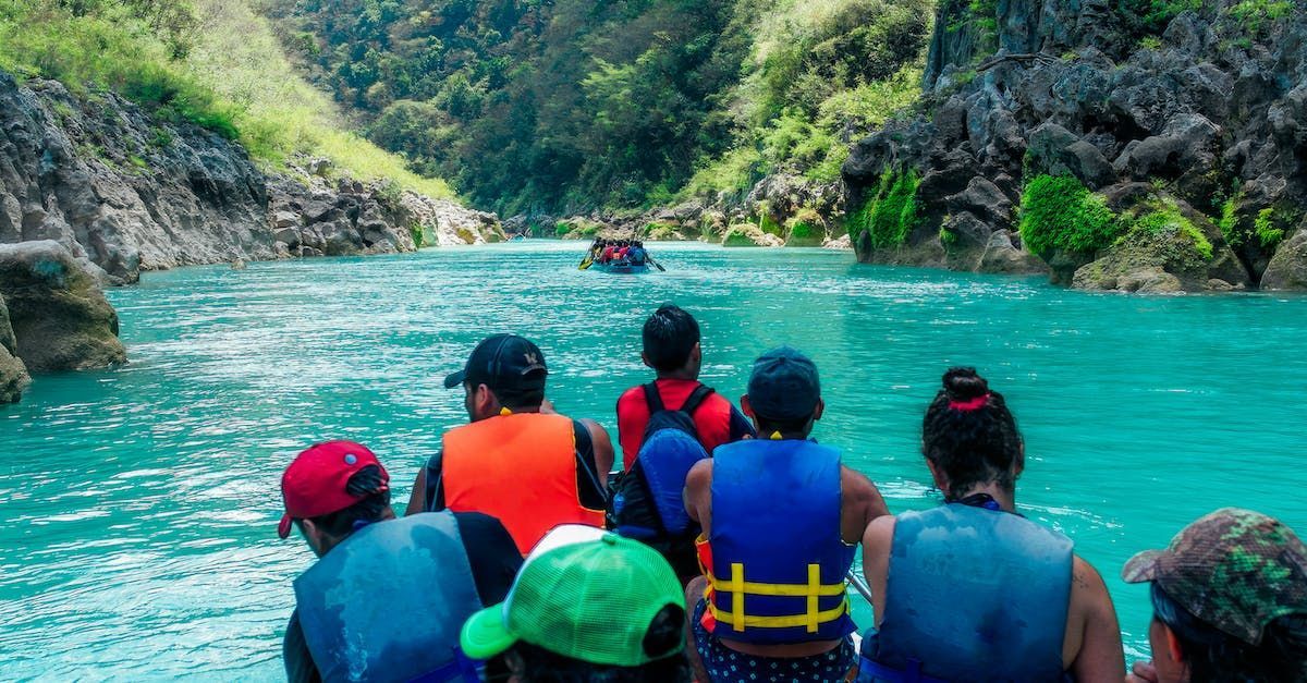 a group of people are riding rafts down a river . Barter's Travelnet 