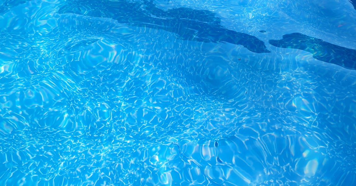 A yellow snow plow is clearing snow from the side of the road.