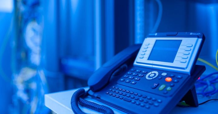 company desk phone with blue tint