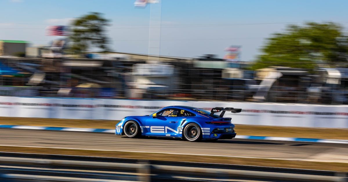 a blue race car is driving down a race track .