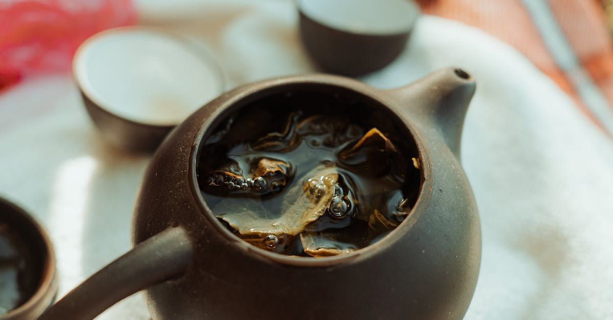 Green tea with caffeine brewing in a jug. Could it cause adrenal fatigue?
