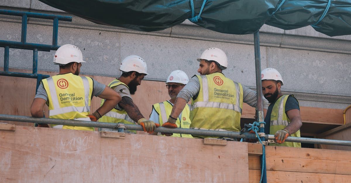 A group of construction workers are working on a building.
