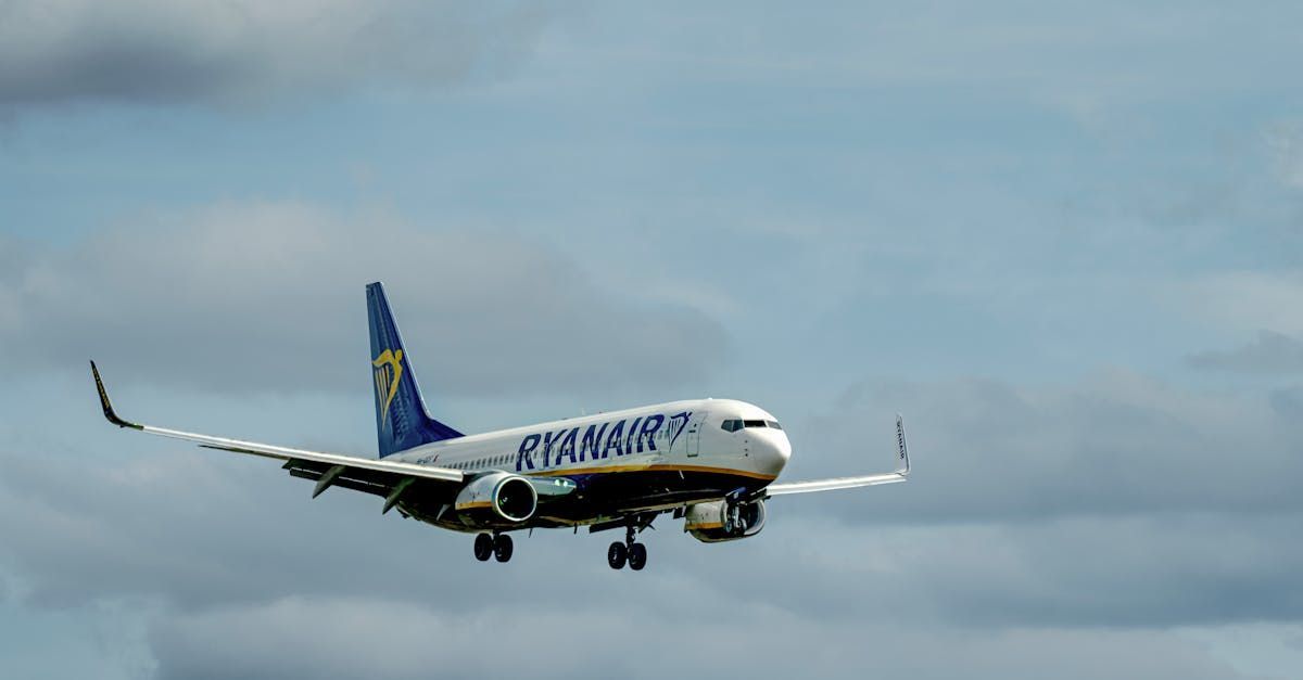 A ryanair airplane is flying through a cloudy sky.