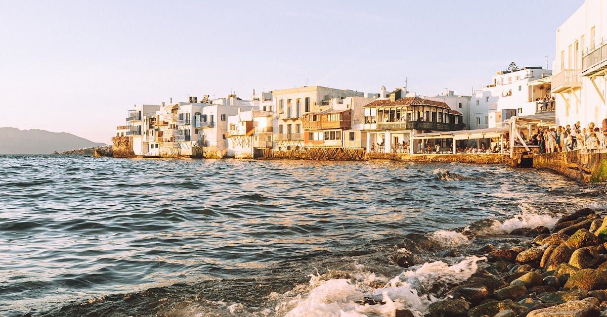 A view of a city from the water with buildings in the background.