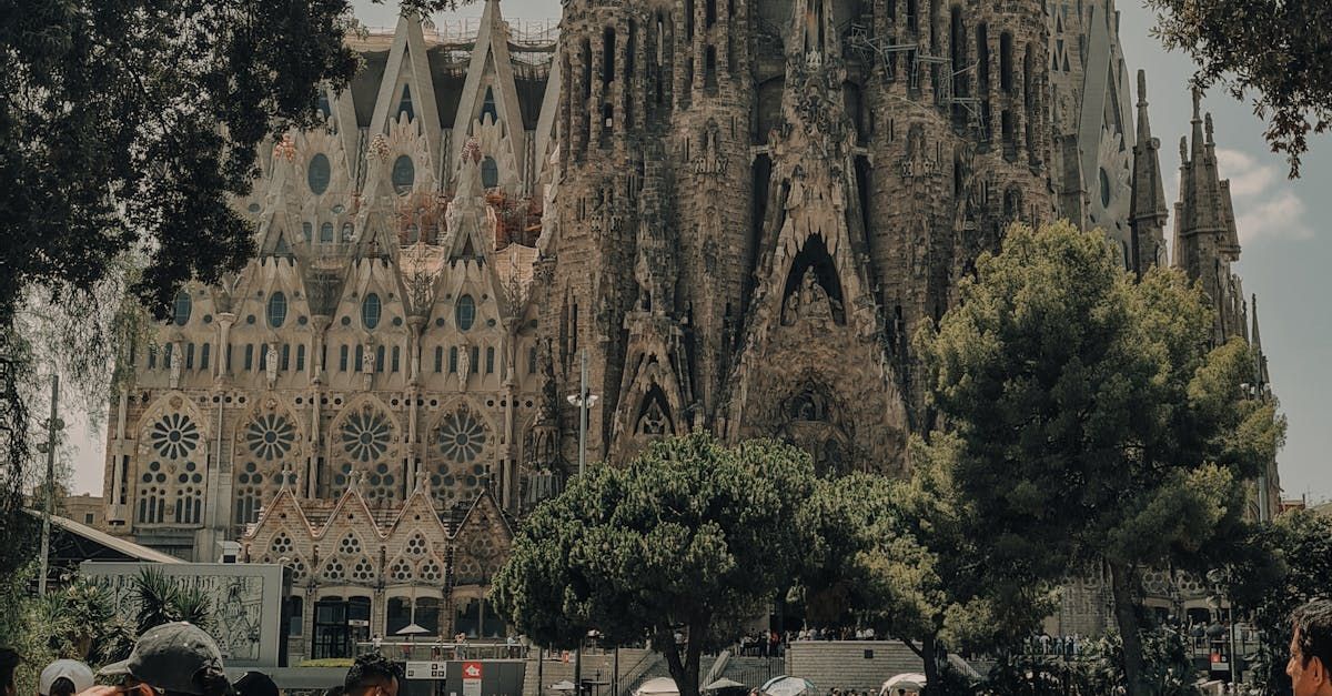 A group of people are standing in front of a large building.