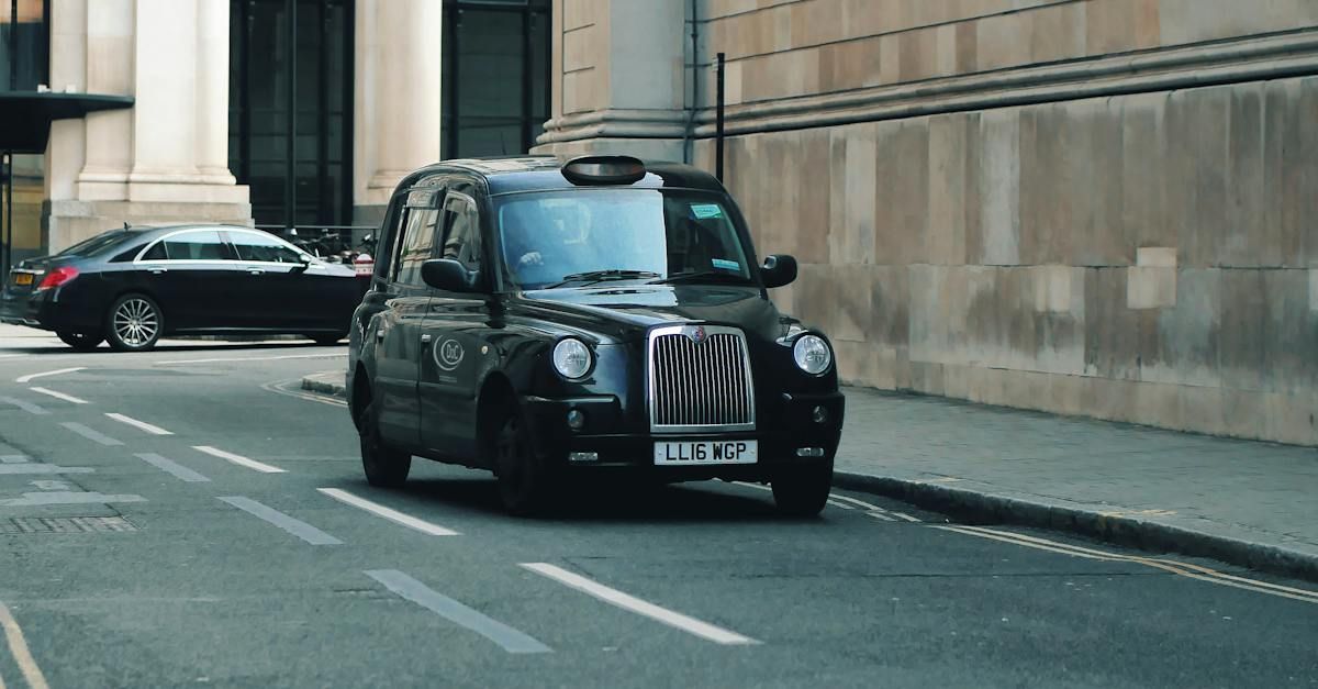 a black taxi cab is driving down a city street 