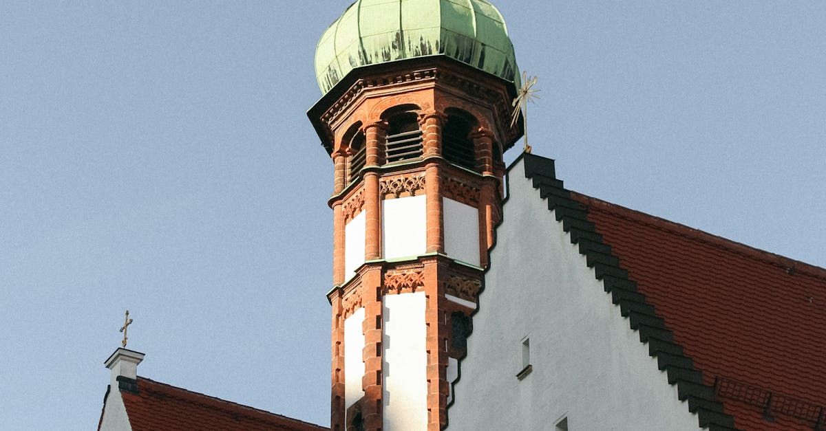 A clock tower with a green dome on top of it