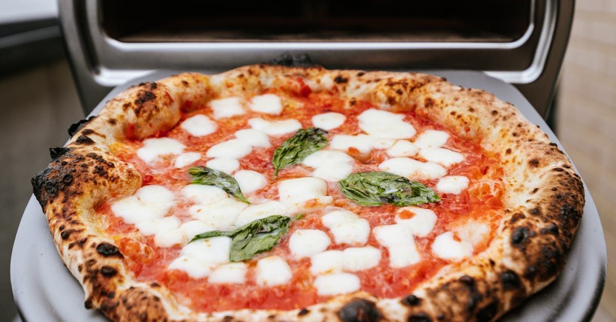A pizza is sitting on top of a white plate on a table.