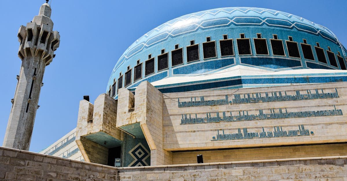 A mosque with a blue dome and a minaret.