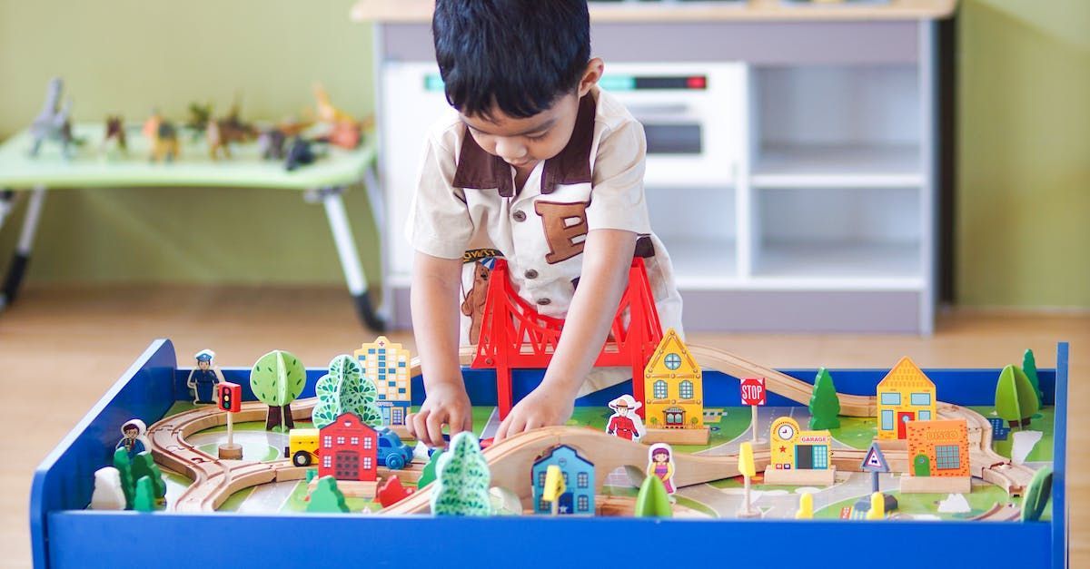 young boy creating small world environment