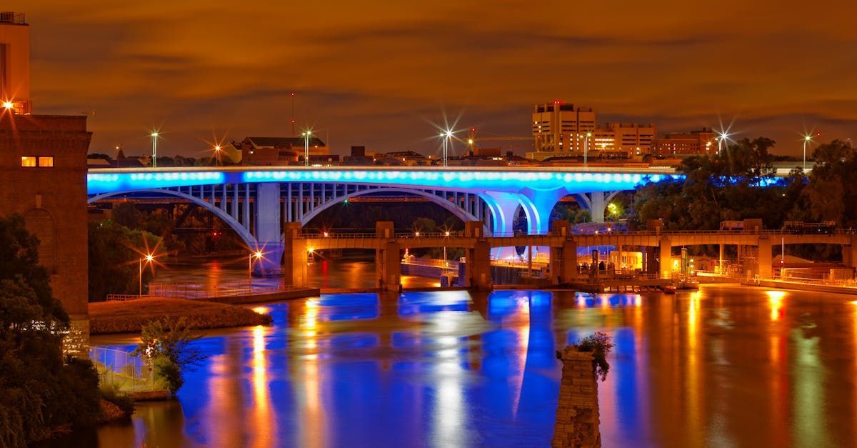 A bridge over a body of water is lit up with blue lights