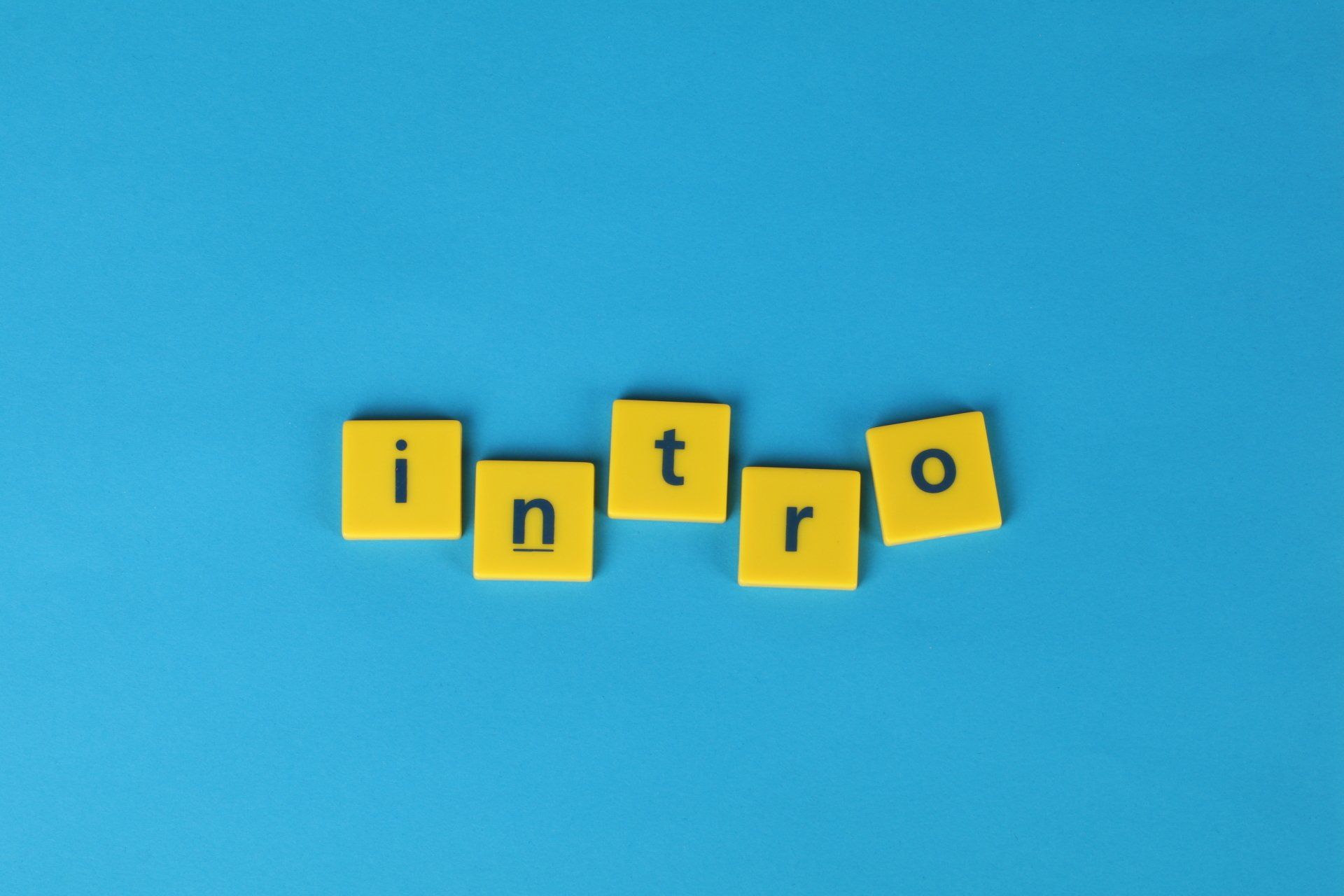 The word intro is written in yellow scrabble tiles on a blue background.