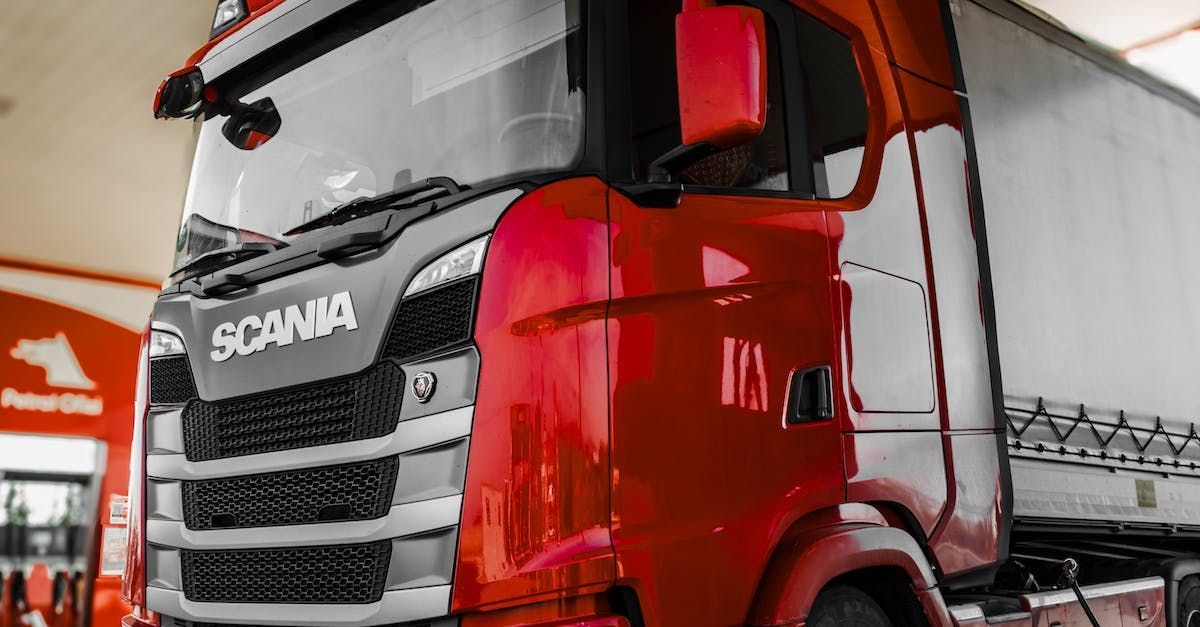 a red scania truck is parked