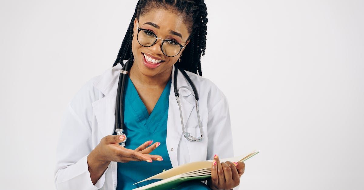 Woman in medical scrubs with stethoscope pointing and explaining the answer to the question How do you customize the medicine for each patient?