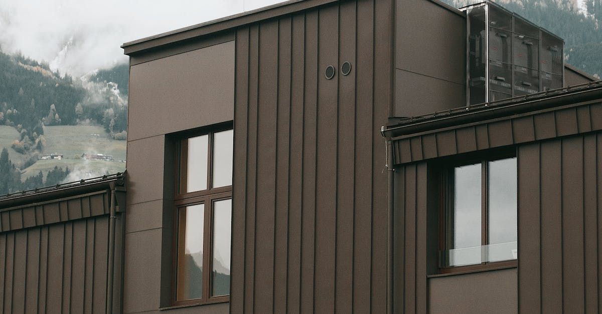 A building with a lot of windows and a mountain in the background.