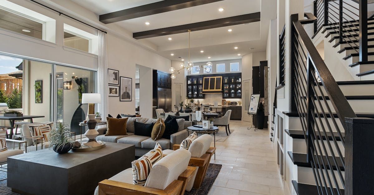 a living room filled with furniture and a staircase in a house .