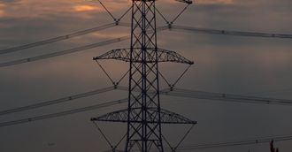 a telephone pole with a sunset in the background