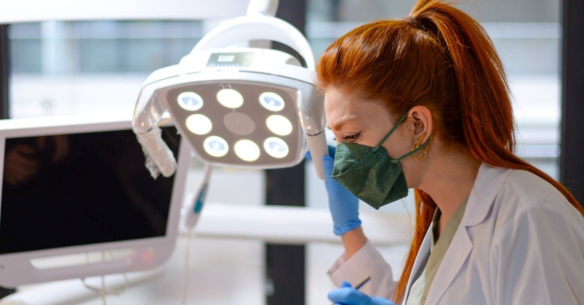 A female dentist wearing a mask and gloves is working in a dental office.