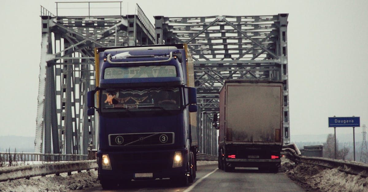 A semi truck with bricks on the back is driving down a highway