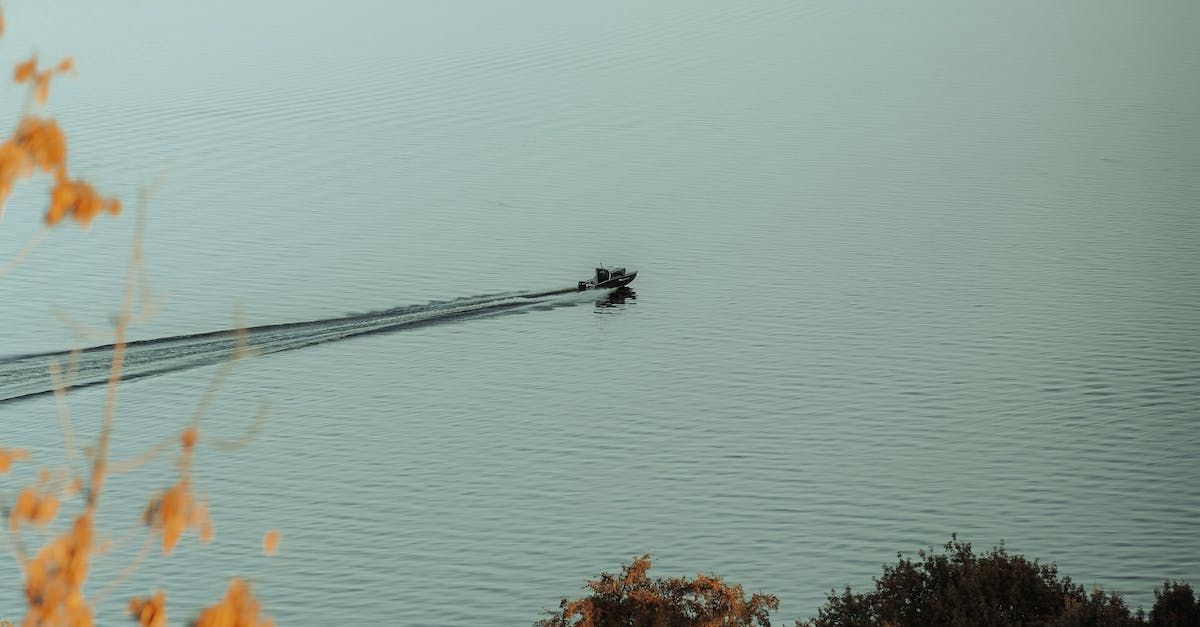 a boat is floating on top of a body of water .