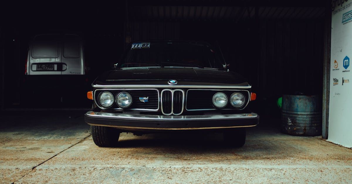 A black bmw is parked in a garage.  | Eurotech German Car Service