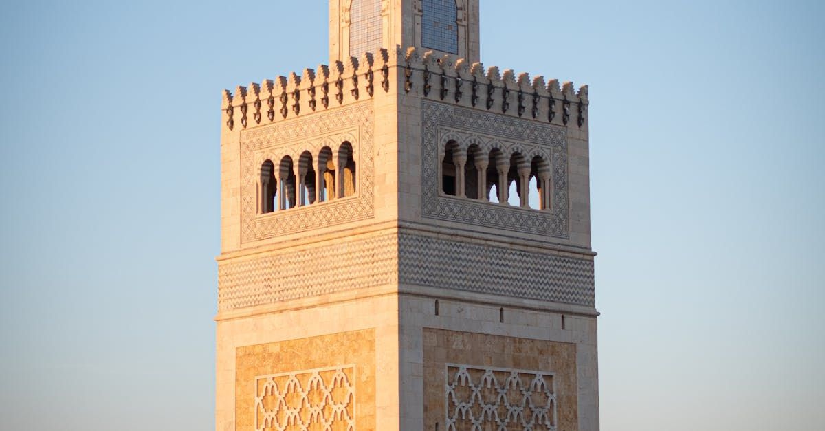 A very tall tower with a blue sky in the background.