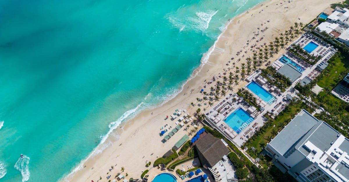 An aerial view of a beach with a lot of people on it.