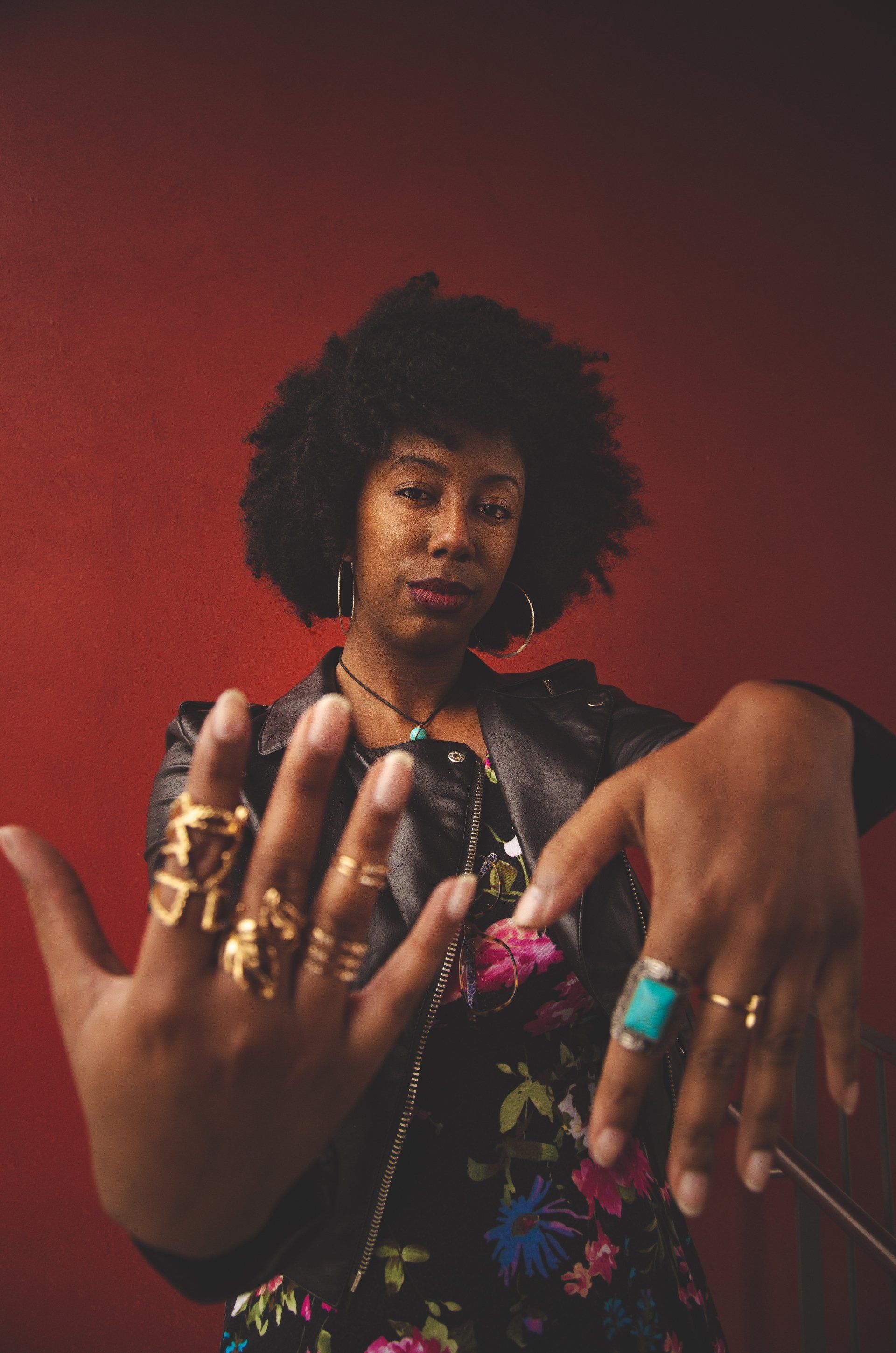 a woman is wearing a lot of rings on her fingers .