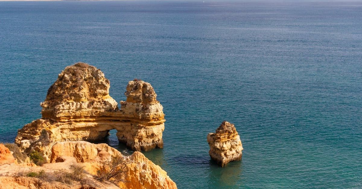 A group of rocks in the middle of the ocean.