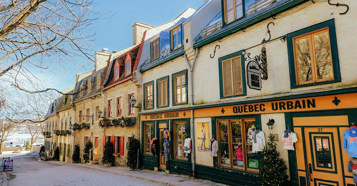 A row of buildings with a yellow sign that says meuble urbain