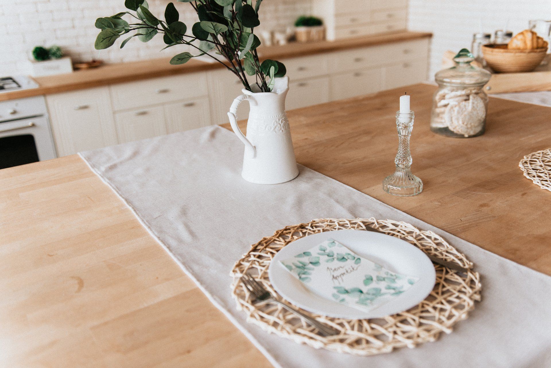a table with a plate and a vase on it in a kitchen . Transform Your Kitchen on a Budget