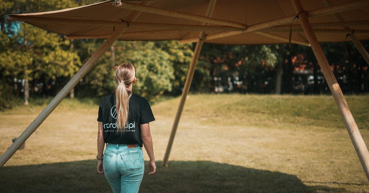 A woman stood with her back to the camera beneath a stretch tent