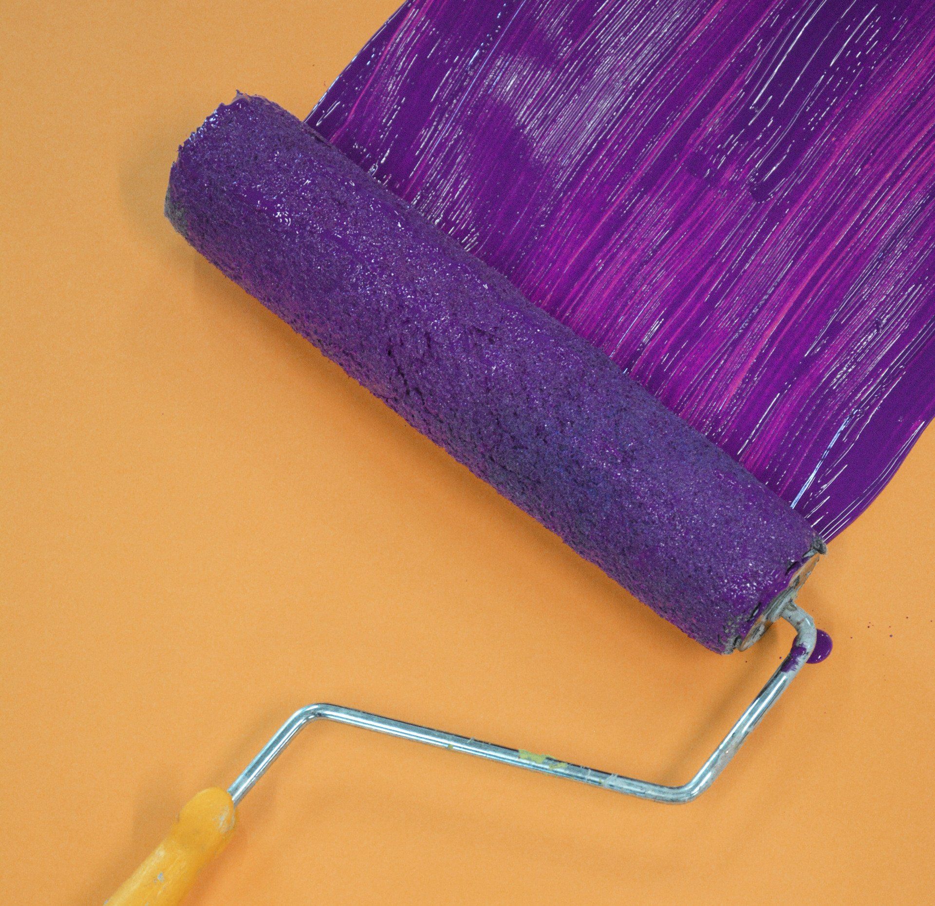 painting a wall with a roller