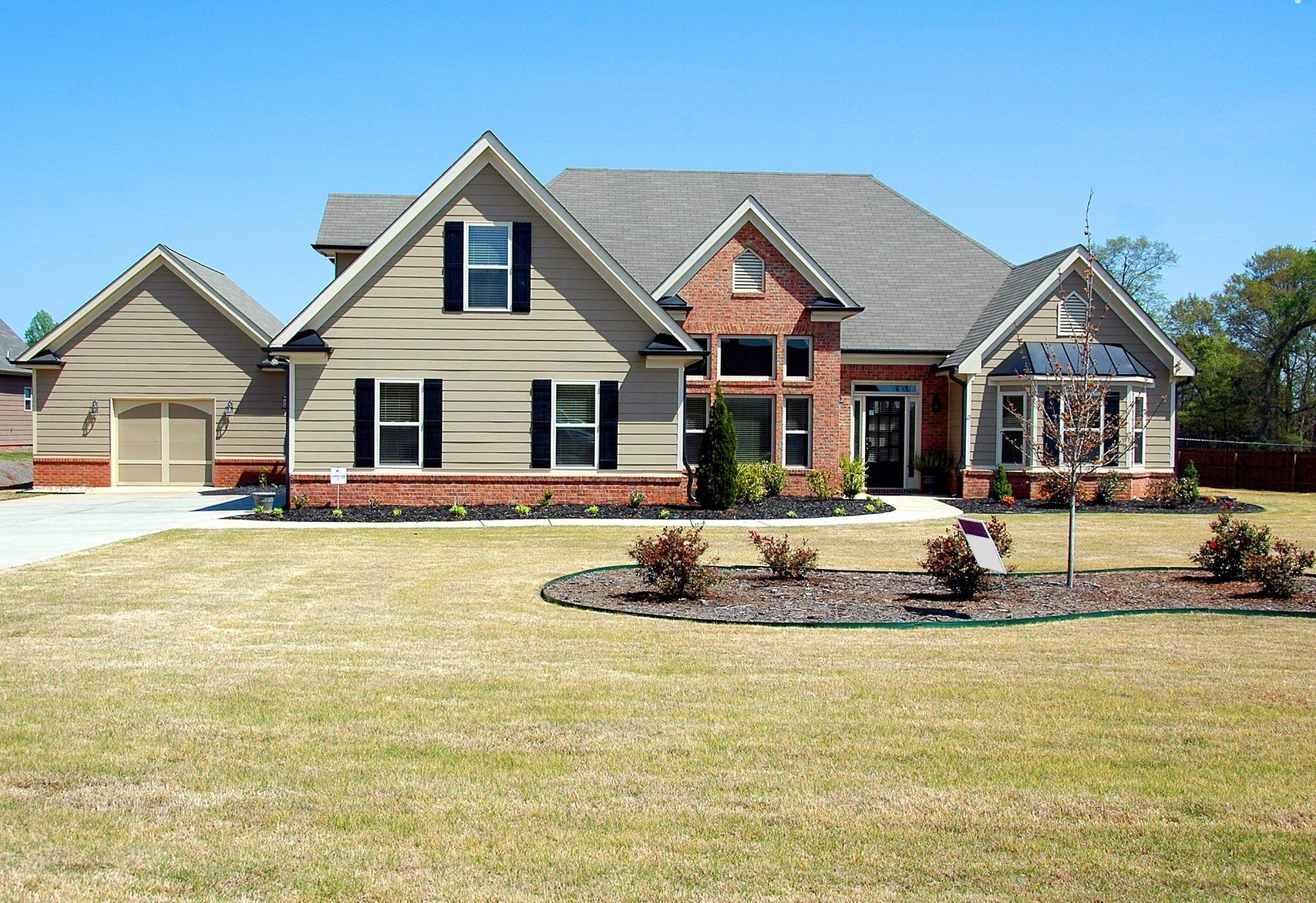 A large house with a large lawn in front of it