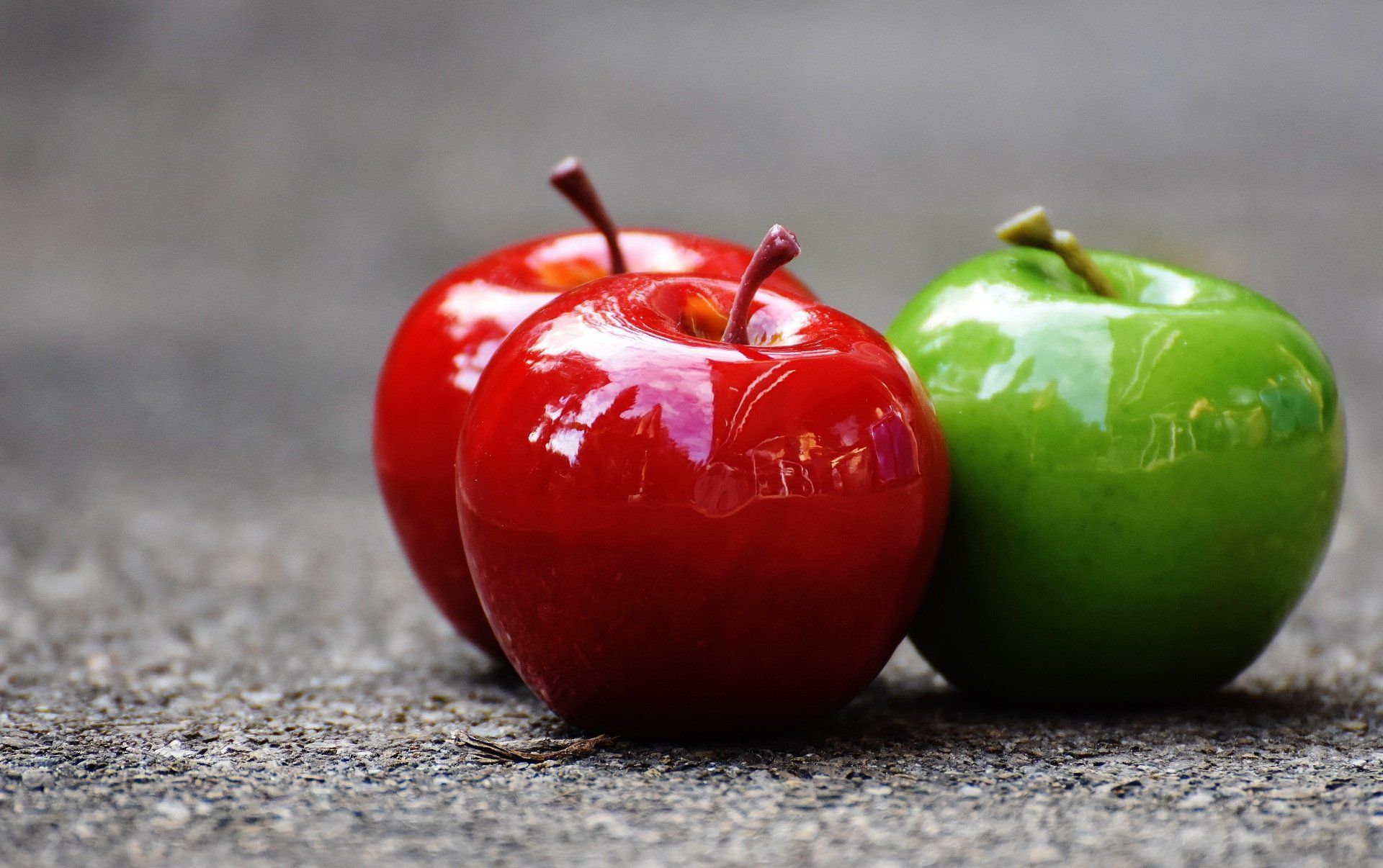 red apples and green apples on flat surface