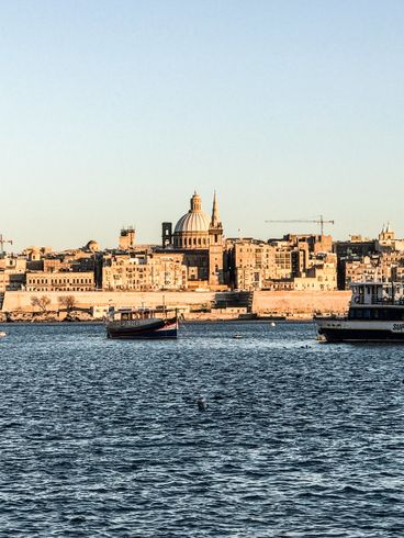 Um grande corpo de água com uma cidade ao fundo