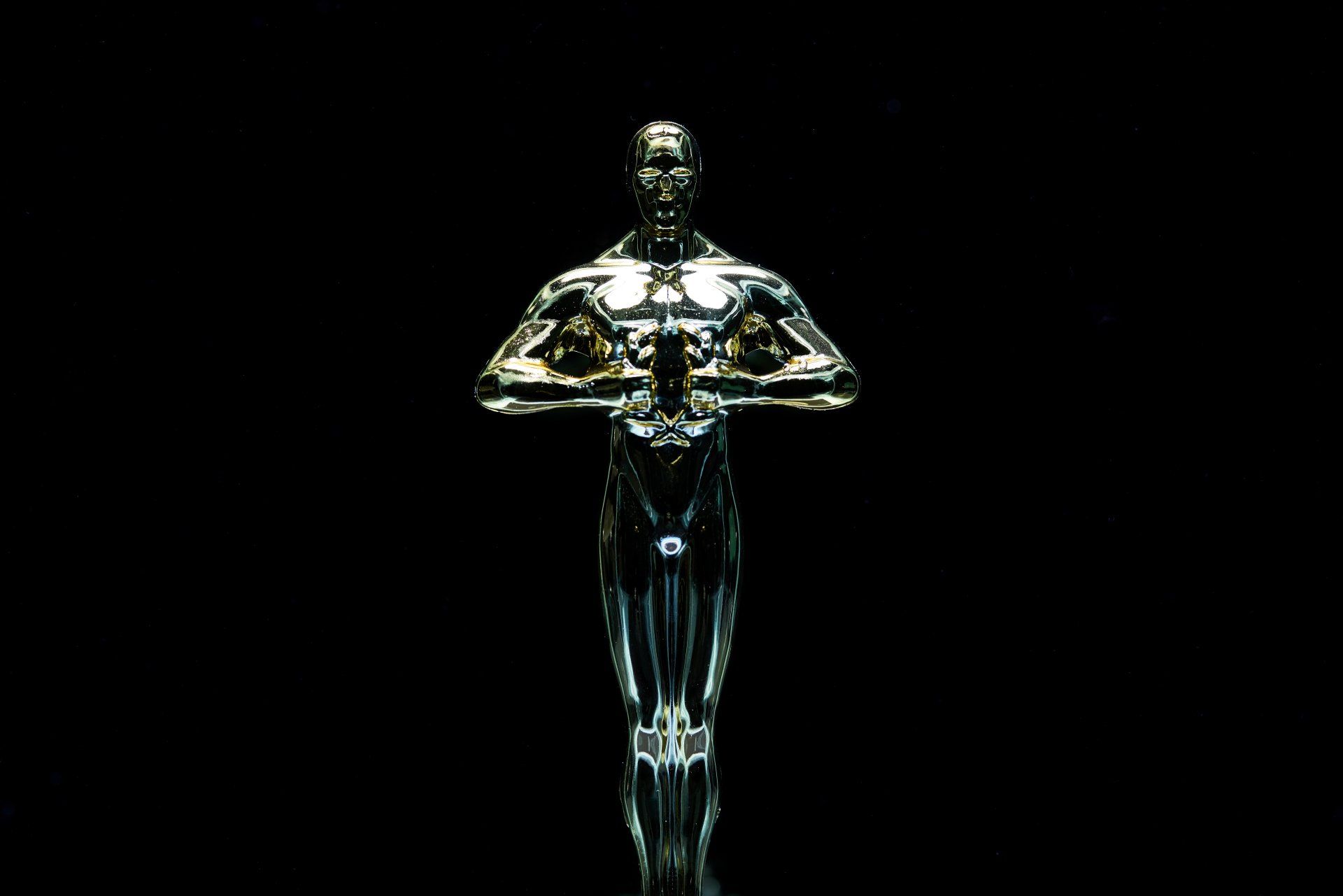 a close-up of an Oscar statue on a black background