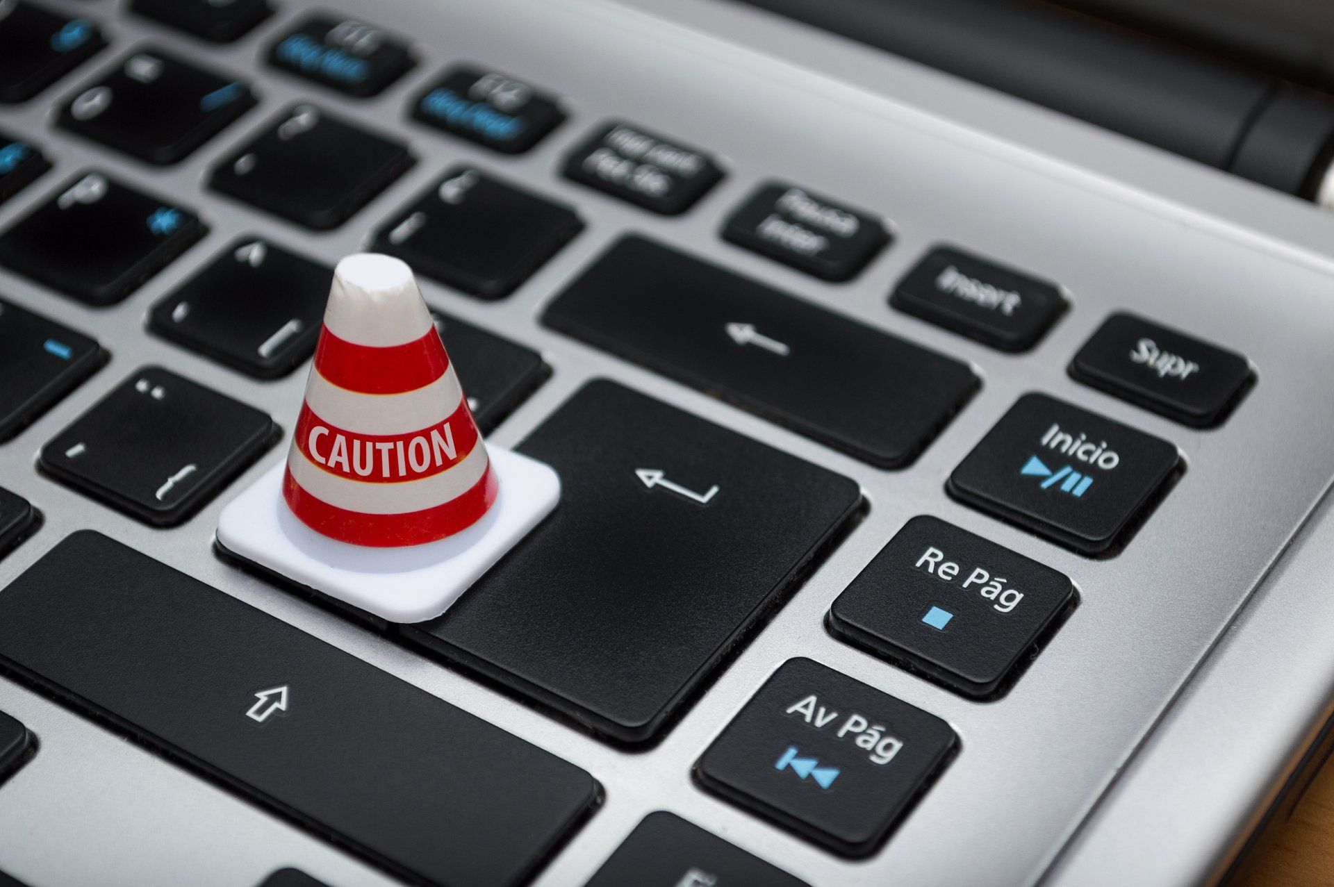 small caution cone on top of a keyboard