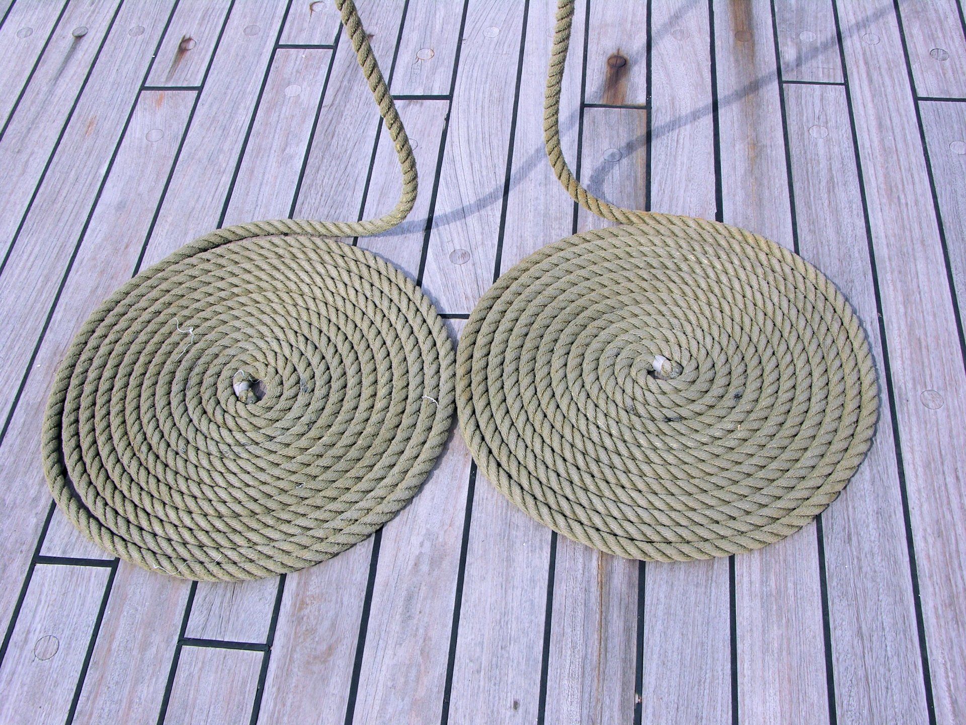 deck made of wood with two coiled ropes