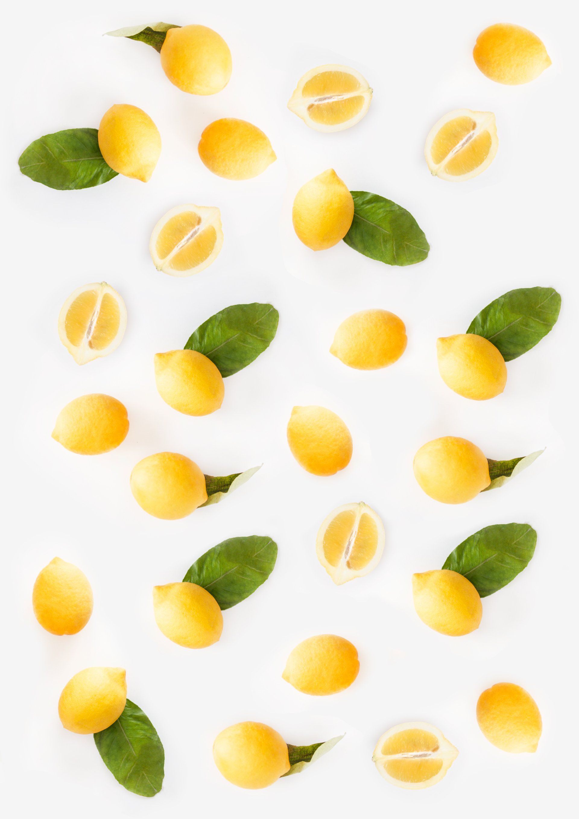 A pattern of lemons and green leaves on a white background.