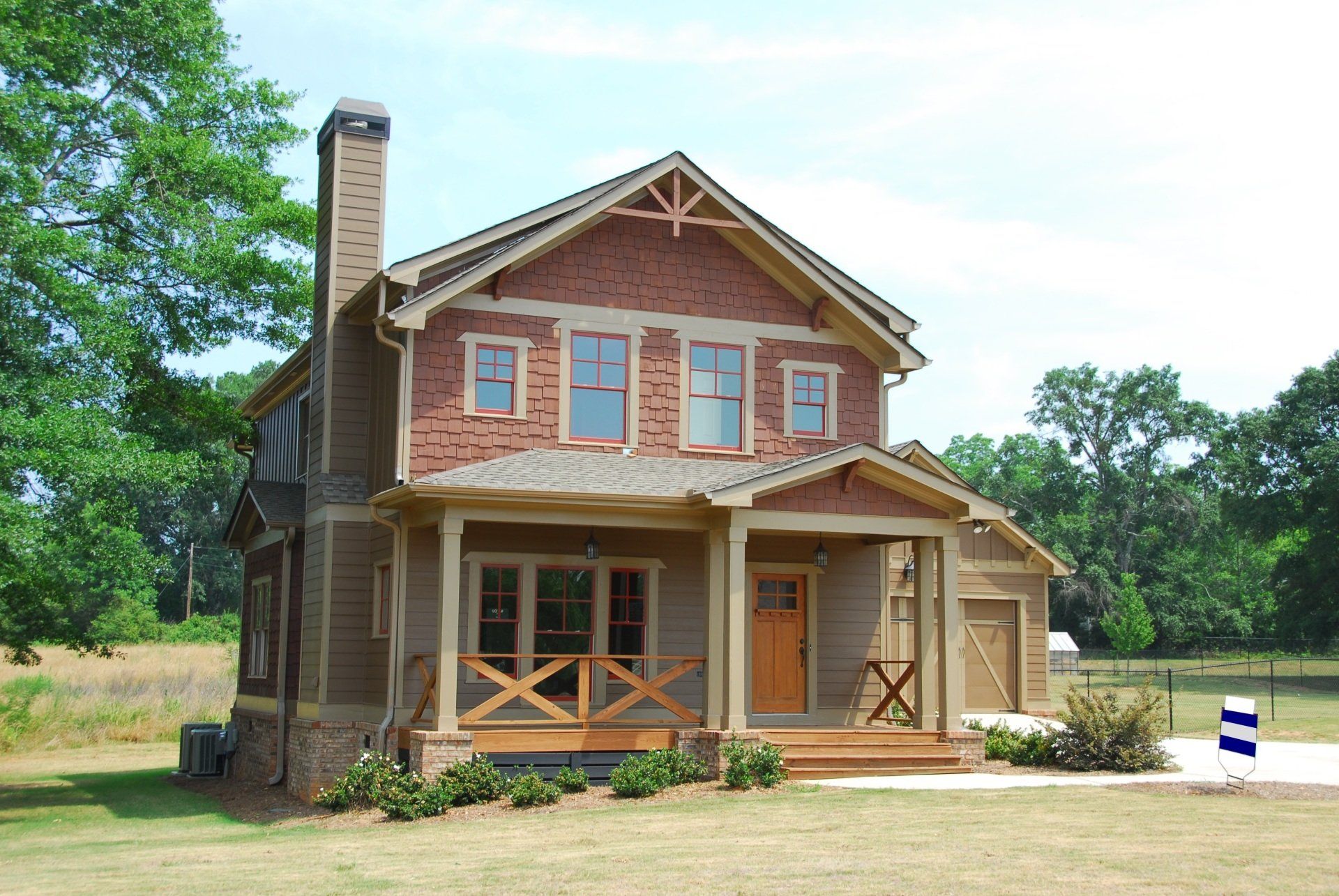 An inviting two-story house with a traditional exterior design featuring a charming chimney, adding character and warmth to the facade.