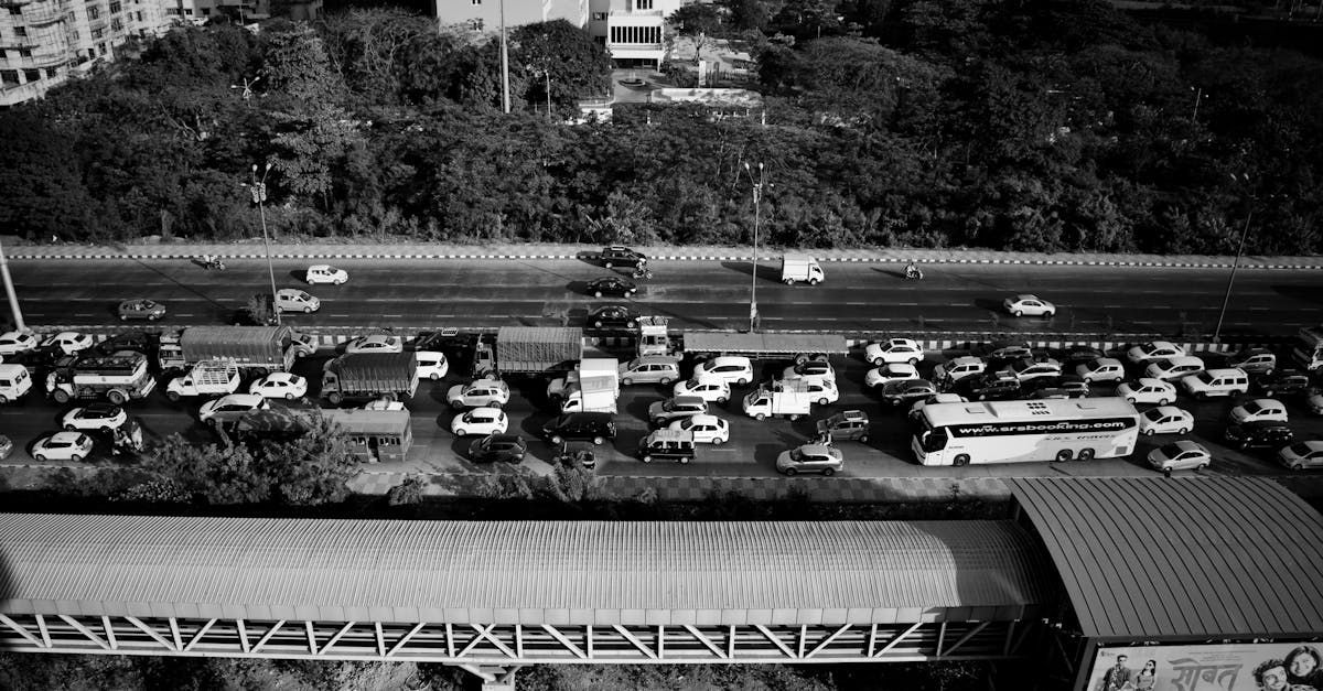 A black and white photo of a busy highway with a lot of cars on it