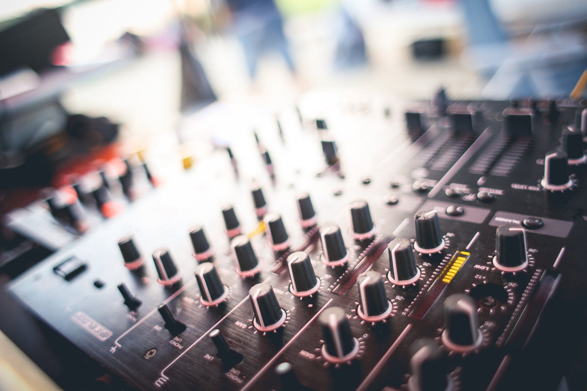 A close up of a mixer with a lot of knobs on it.